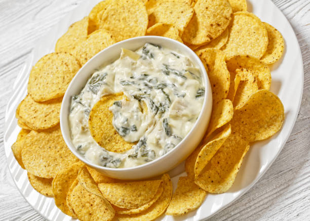 istock artichoke spinach almond dip with potato chips 1688757981