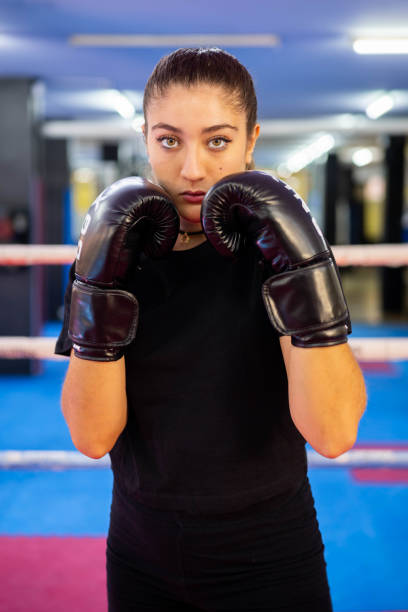 istock Female boxer portrait in guard position in a boxing ring 1688769629