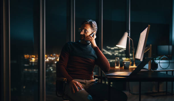 istock Entrepreneur's night call: Business communication at office desk 1688788451