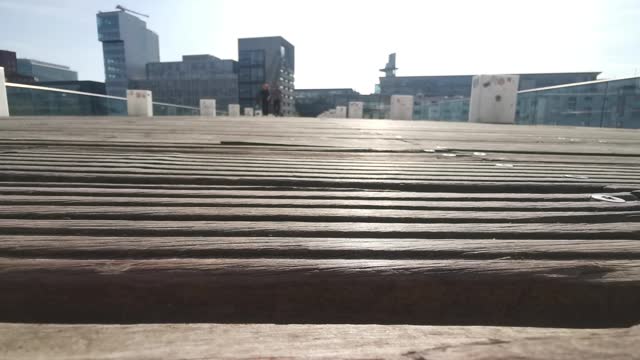 Video close-up of the wood of the bridge in the Medienhafen Düsseldorf while people walk over it