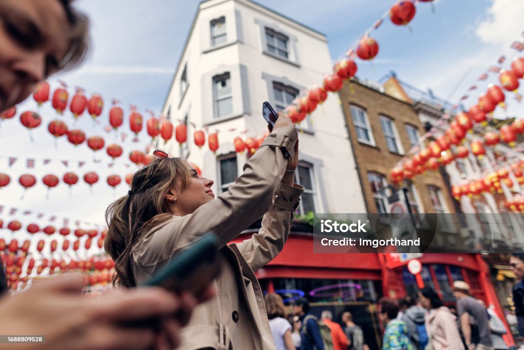 Teenage girl sightseeing Chinatown in London, United Kingdom Teenage girl sightseeing Chinatown in London, UK. The girl is walking in the street and she is filming with her smartphone.
Canon R5 Chinatown Stock Photo