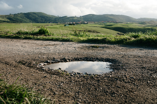 A water puddle on a rural road