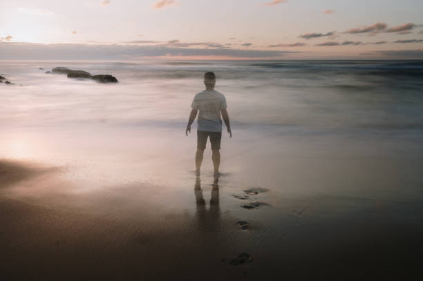 Groom silhouette in summer sunset near sea