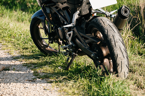 Detail of a motorbike by a rural road