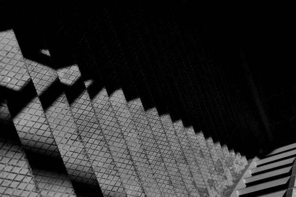 istock Black and white old rusty metal stairs with shadows 1688864250