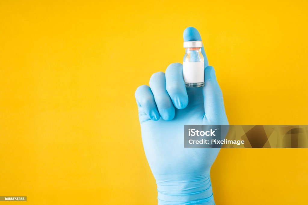 Doctor's hand shows vaccine Booster Dose Stock Photo