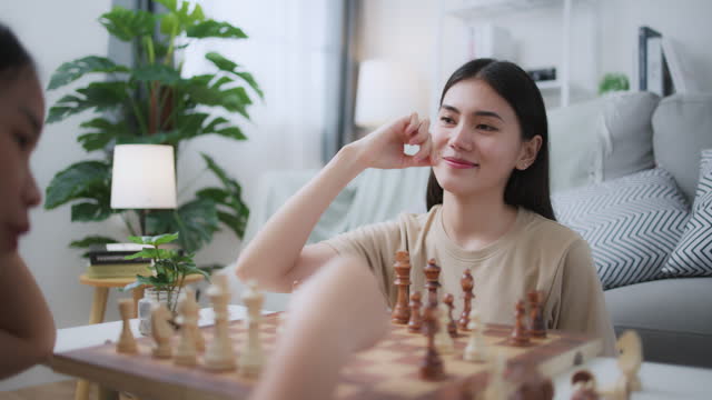 Woman Play Strategic Board Games with Friend, Enjoy Chess Competition at Home
