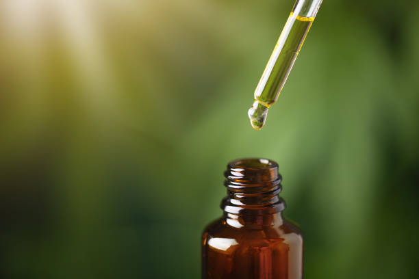 istock CBD hemp oil on cannabis leaf background. 1688882848