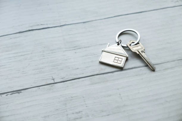 istock House key on wooden background. 1688890921