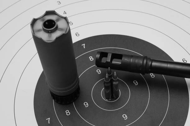 istock Silencer, rifle barrel and cartridges on the paper target 1688893666