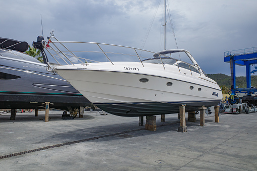 Port d'Andtrax, Spain - 7 May, 2023: Drydock Yachts and Cranes in Port d'Andratx, Mallorca