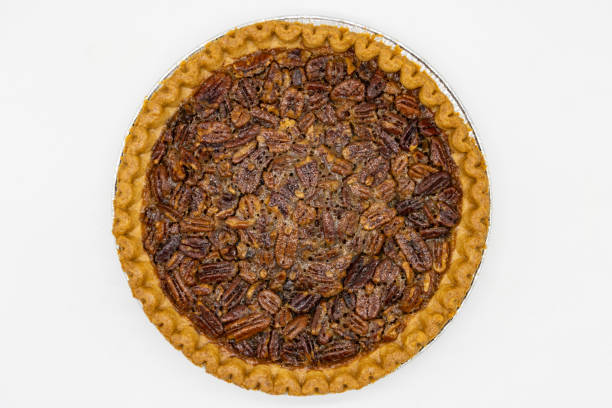 istock Overhead View of a Pecan Pie on a White Background 1688907175