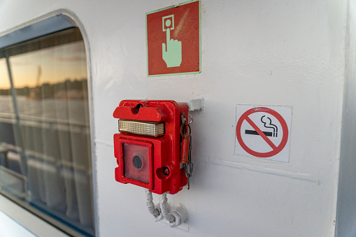 emergency fire alarm button on the ship. Announcement of an emergency fire situation on the ship. Emergency situation. High quality photo