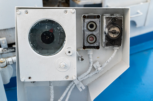 Electric deck control panel for lifting and lowering the anchor chain. Key and control buttons of the anchor winch, Arrow pointer close-up