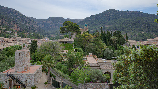 Scenic view of town amidst forest and mountain against clear blue sky