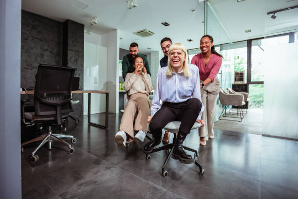 istock Group of professional people racing with the chairs while on a break in the modern office 1688917029