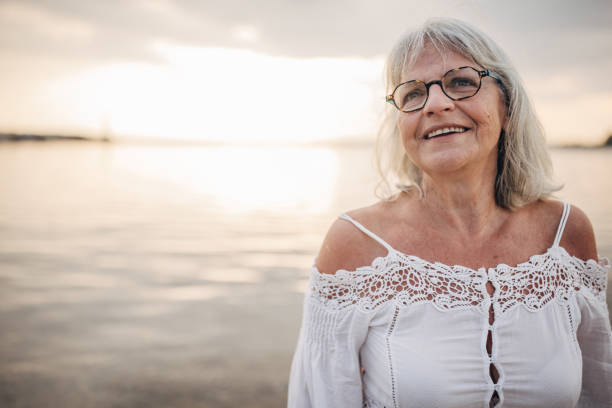 istock Old woman by the sea 1688922676