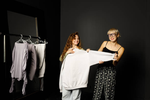 istock Stylist designer helping choose clothes dress to customer client. 1688931049