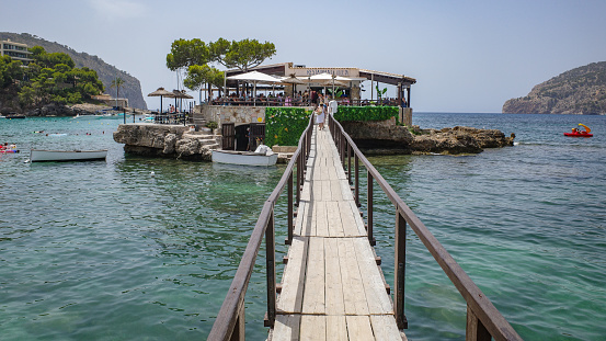 Mallorca, Spain - 11 July, 2023: Restaurant Illeta pier in Camp de Mar, Mallorca, Balearic Islands