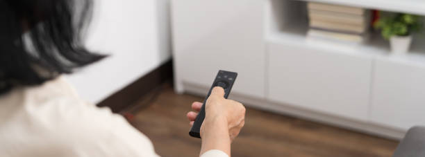 istock Elderly woman Watching smart TV and using remote controller Hand holding television audio remote control Middle age Asian woman movie Television series spending time at home 1688945473