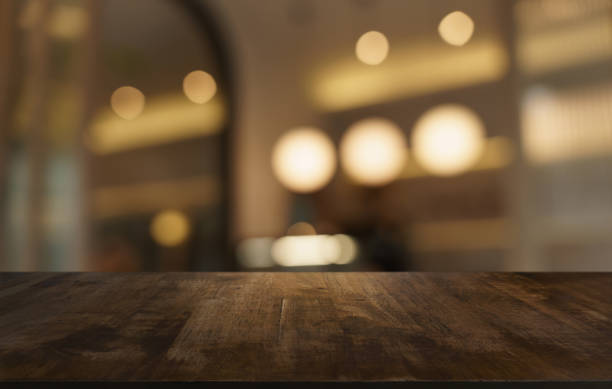 istock Mock up for space. Empty dark wooden table in front of abstract blurred bokeh background of restaurant . can be used for display or montage your product 1688948326
