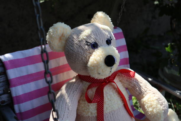 istock Teddy bear on a swing outdoor. 1688953377