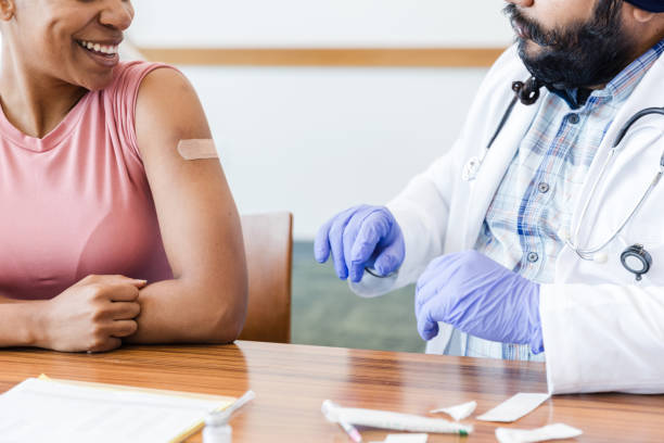istock Unrecognizable woman smiles after getting immunization from male doctor 1688953383