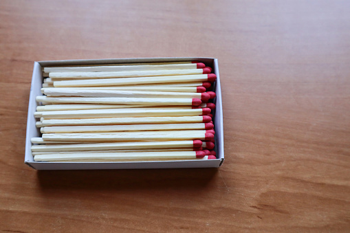 Box of matches on the wooden table, close up.