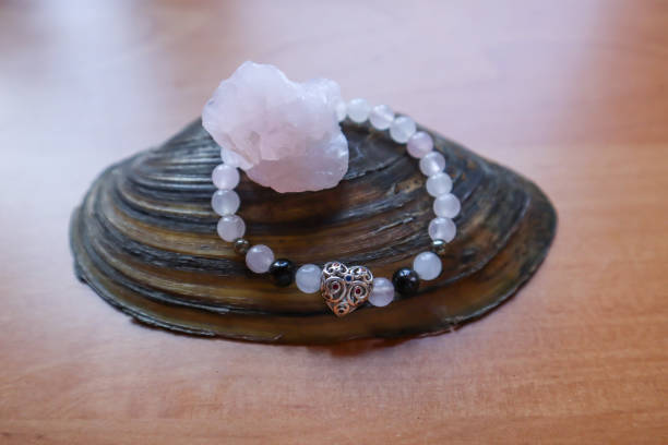 istock Rose quartz and bracelet from crystals on the natural shell. 1688963698