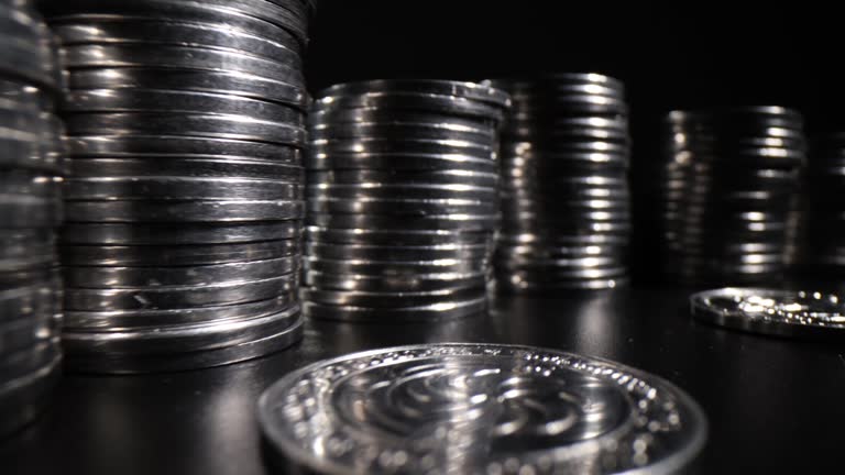 Stack of silver coins on black background