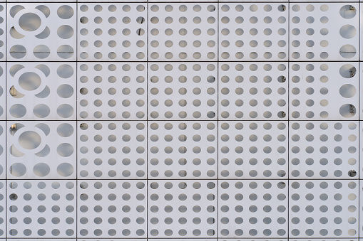 Close up of a wall of gray color with a pattern of circle geometric shapes