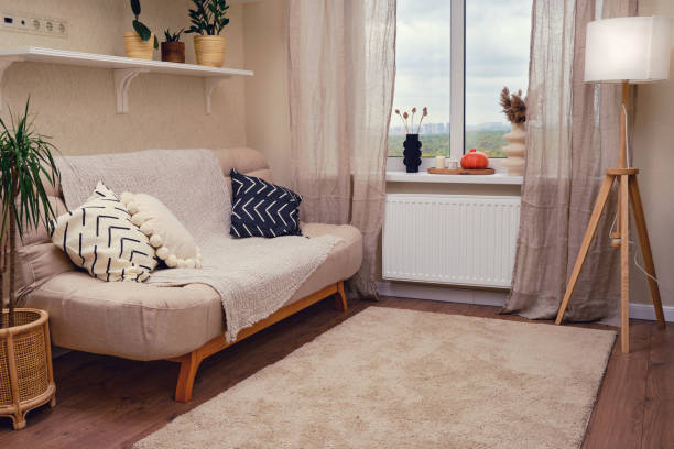 istock Interior of a living room with a sofa and a window. 1689008839