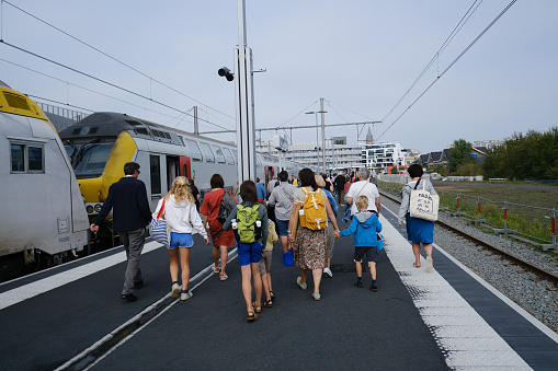 Passengers walk on a platform after a commuter train arrived at railway station in Blankenberge, Belgium on Sep. 17, 2023.
