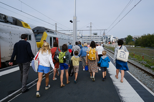 Passengers walk on a platform after a commuter train arrived at railway station in Blankenberge, Belgium on Sep. 17, 2023.