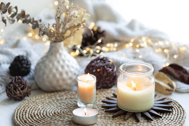 istock Cozy composition with candles on a blurred background with garland lights. 1689018852