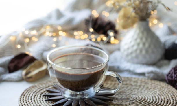 istock Composition with a cup of coffee on a blurred background with a knitted element. 1689018866