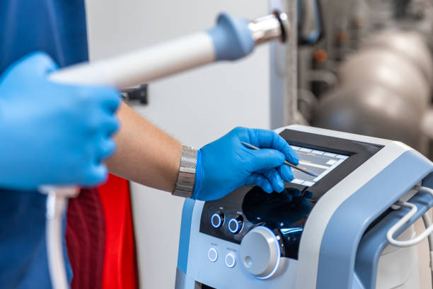 istock Shock wave therapy device with male doctor hands in rubber gloves. 1689020680