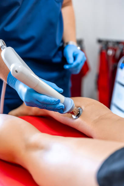 istock Physical therapy of the shin with shock wave, extracorporeal shockwave therapy. 1689020705