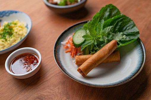 Traditional Vietnamese eggrolls served with herbs and pickled vegetables