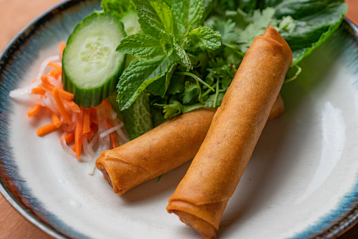 Traditional Vietnamese eggrolls served with herbs and pickled vegetables