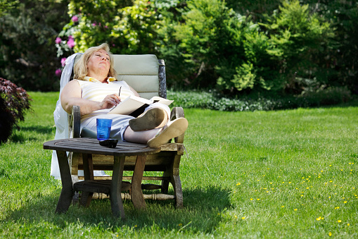 Mature woman napping in a garden chair