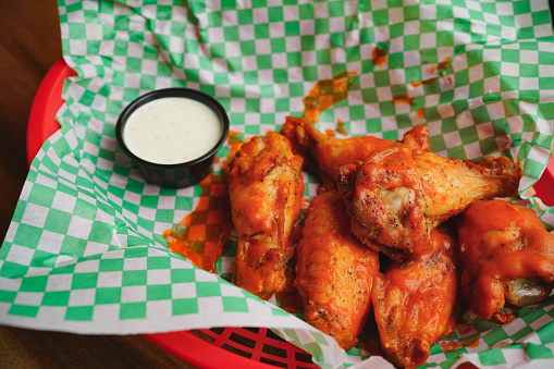 Buffalo wings with hot sauce and blue cheese dipping sauce