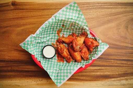 Buffalo wings with hot sauce and blue cheese dipping sauce