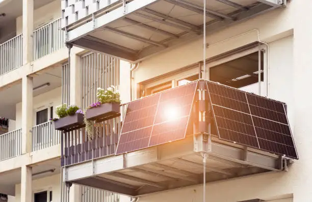 Solar Panel on Balcony Flat or Apartment Building. Solar Modern Balcony with Sun Light Reflection in Green City. Solar Technology Equipment. Green Energy Concept.