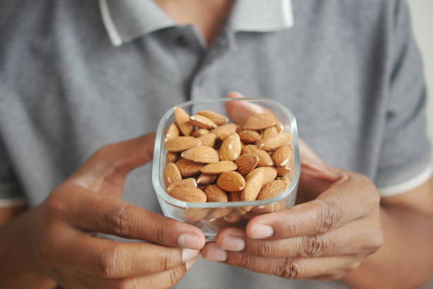 istock close up of almond nuts on man's hand 1689073521