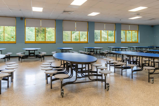 istock Blue folding table with attached seats in a school cafeteria. 1689074595