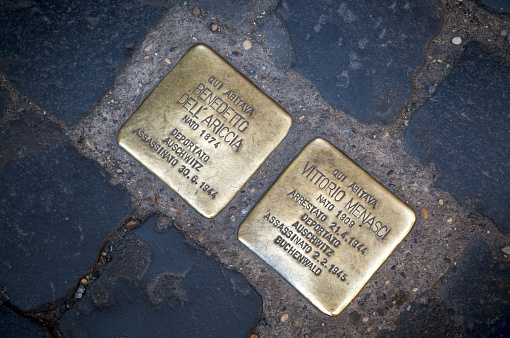 These polished brass stones, shaped square like a Roman cobble and engraved with the name of a local Jewish resident, marks the exact spot where Holocaust victims were rounded up by Nazi soldiers during WWII and deported to Auschwitz or other death camps.