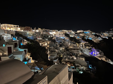 Beautiful famous view of the white town and windmills\nThe beautiful Oia at night, Santorini, The Greek Islands