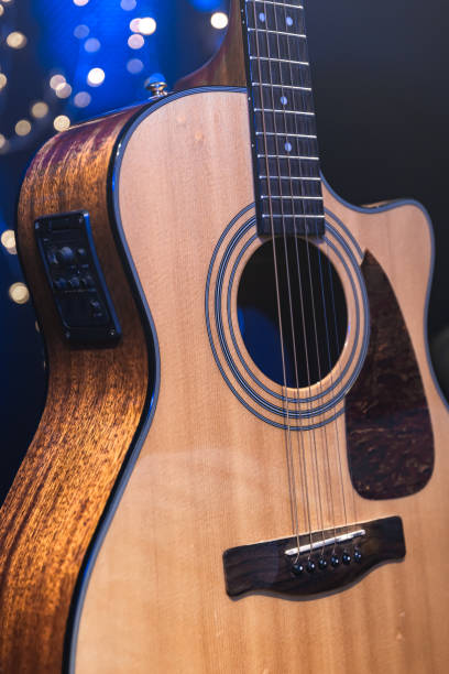 istock Close-up, acoustic guitar on a dark background with bokeh lights. 1689088108