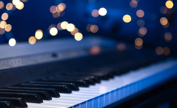 istock Piano keys close-up on a blurred background with bokeh. 1689088123
